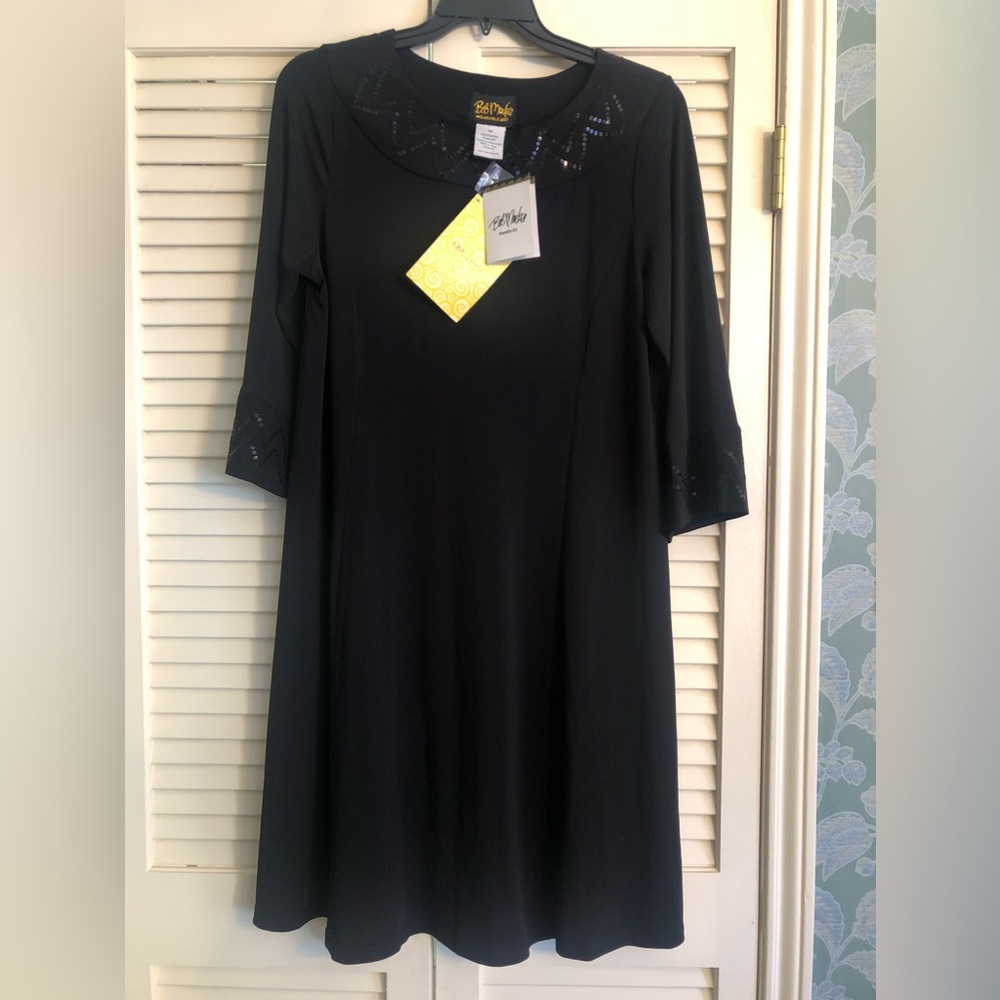 Medium, black dress with sequins trimmed on the neck area & sleeves.